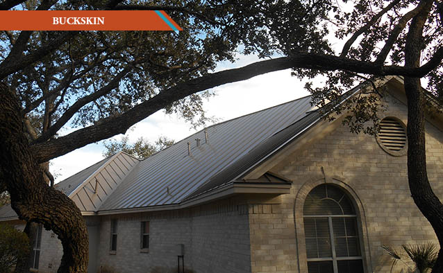 A Buckskin style metal roof on a grey brick two story house.