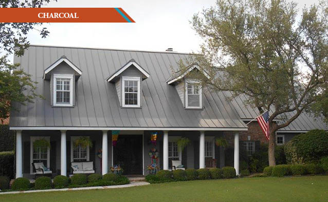 A Charcoal style metal roof on a grey two story Colonial house with wrap around front porch.