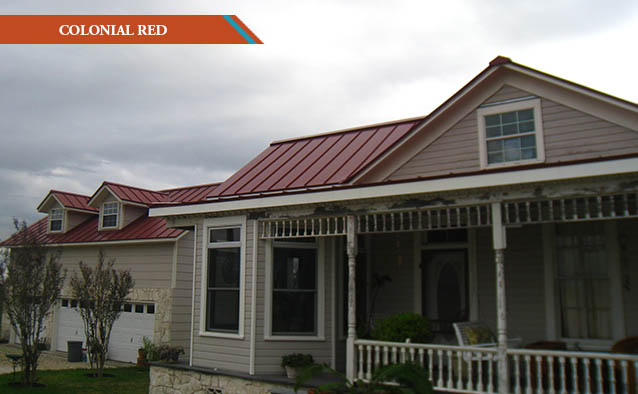 A Colonial Red style metal roof on a two farm house with wrap around front porch.
