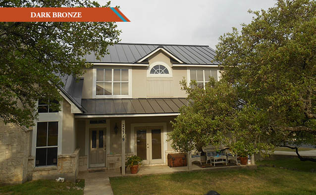 A Dark Bronze style metal roof on a white stucco two story house with covered front porch.