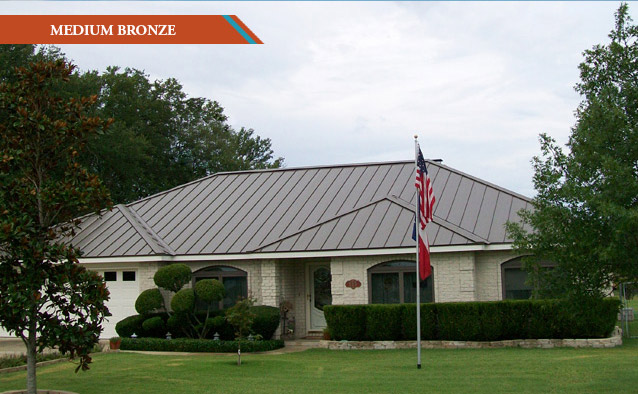 A Medium Bronze style metal roof on a white brick one story house.