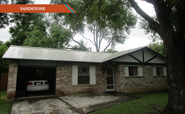 A Sandstone style metal roof on a brick one story ranch style house.